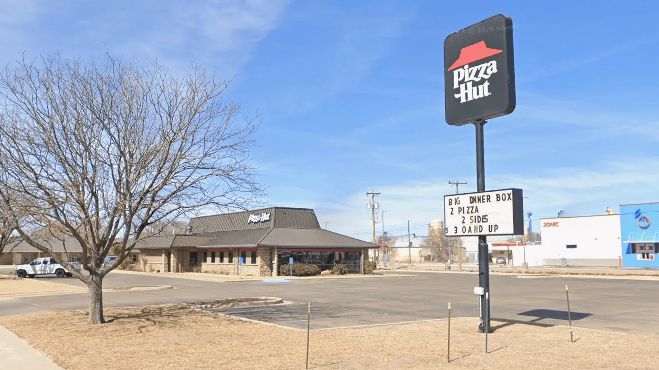 Police search for a masked armed suspect after a Pizza Hut robbery in Portales