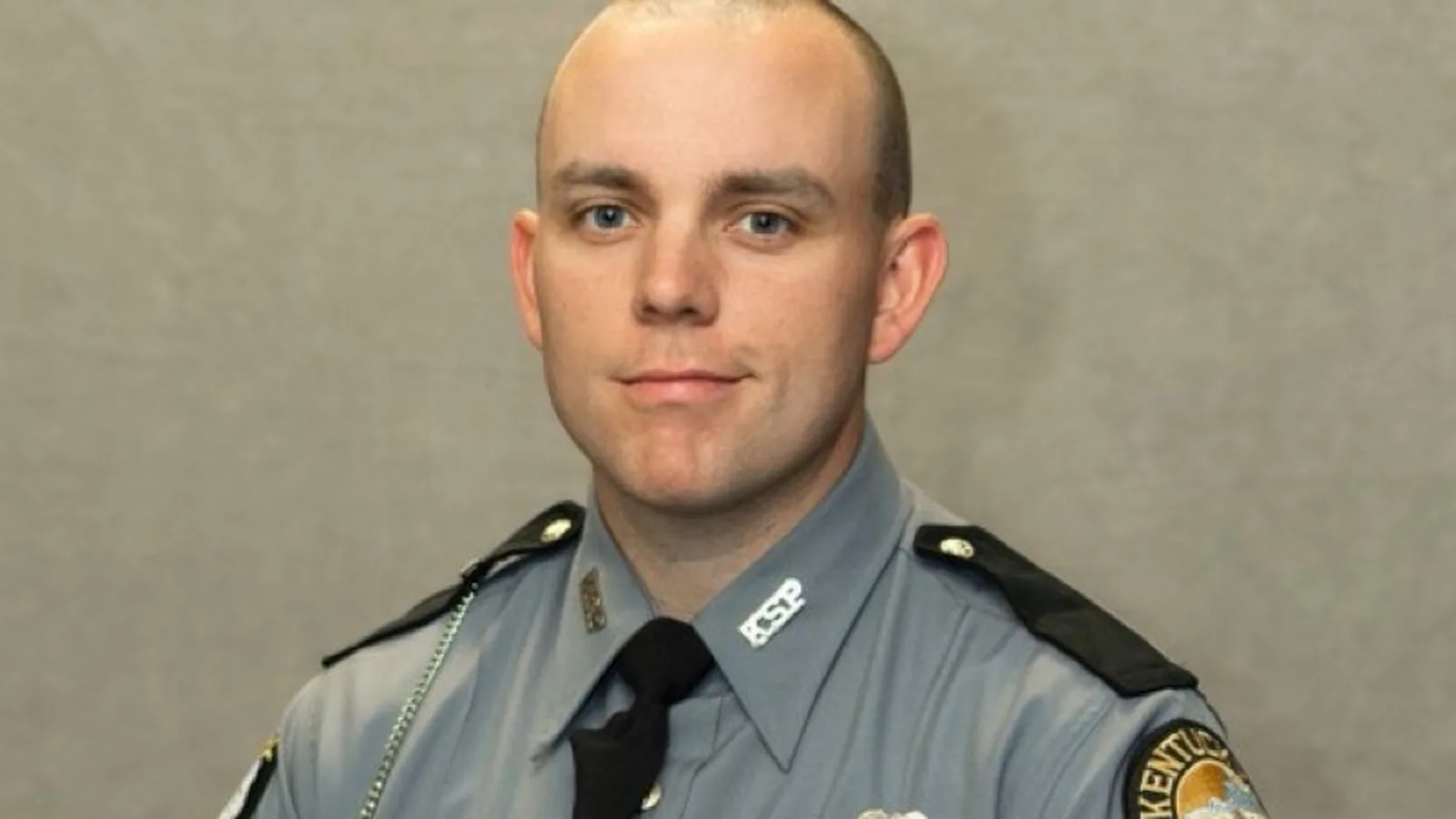Kentucky State Police vehicles escort a fallen trooper's body after the fatal Interstate 65 shooting