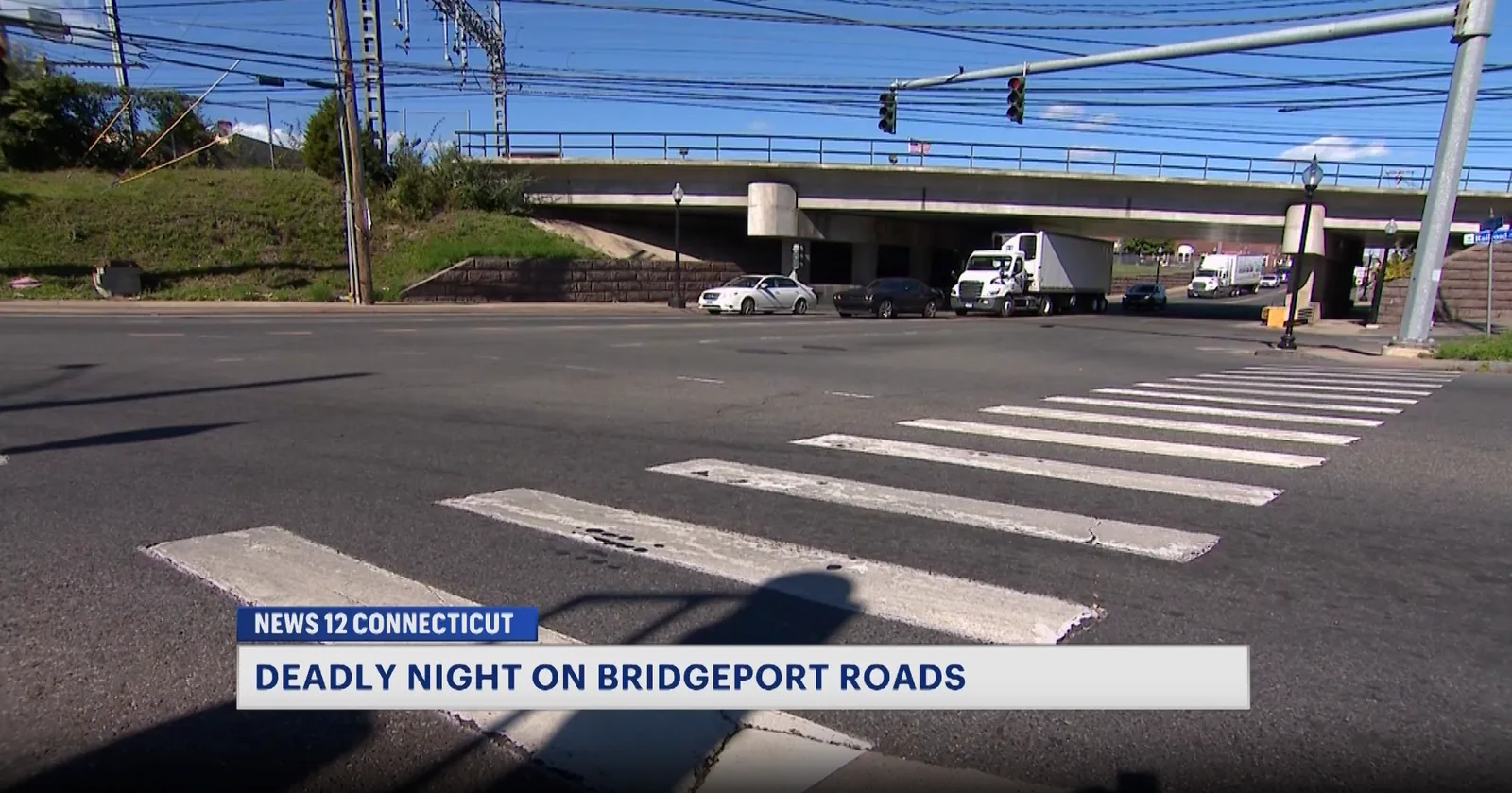 Police investigate debris and damage near a fatal overnight crash scene in Bridgeport