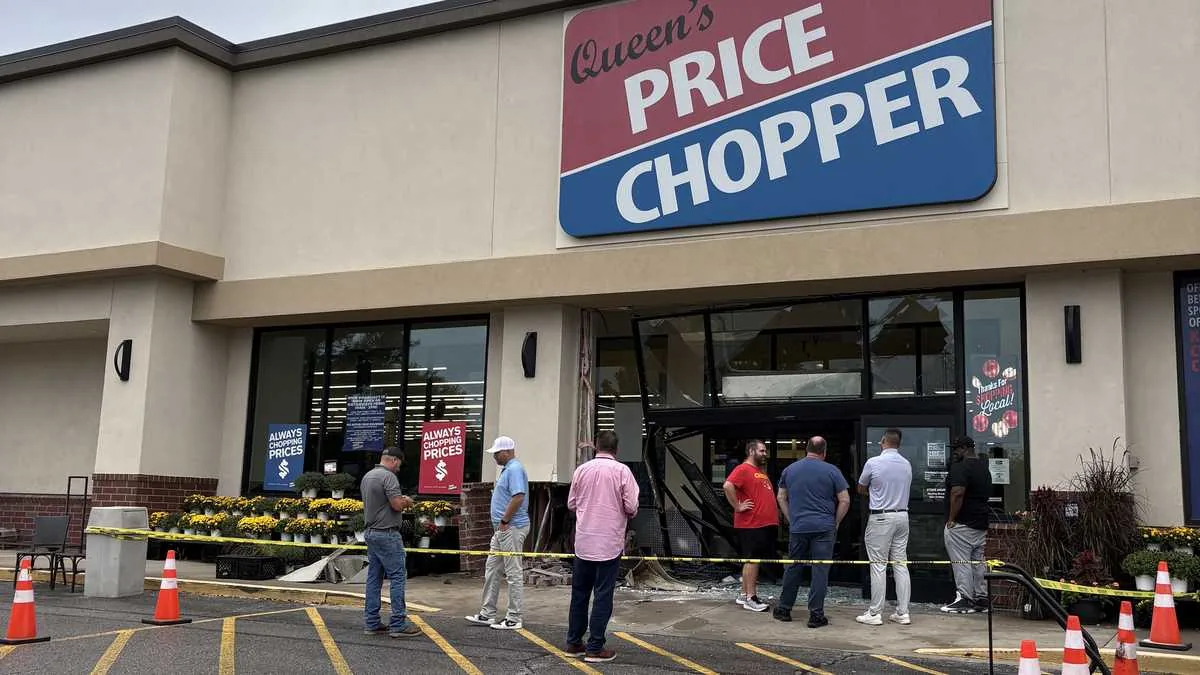 Police and fire crews respond after a car crashes into a Price Chopper entrance in Overland Park